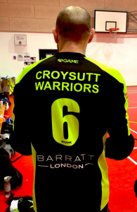 James Hill standing with his back to the camera wearing his black and fluorescent number 6 shirt.