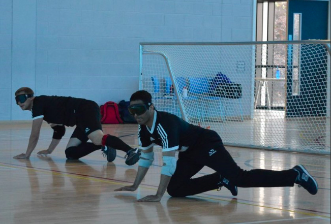 Riyaz Hazi of Kirklees Goalball Club in a ready position in centre of the court.