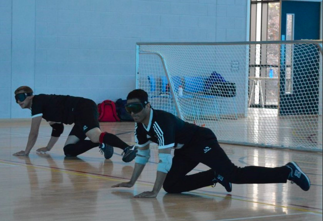 Riyaz Hazi of Kirklees Goalball Club in a ready position in centre of the court.