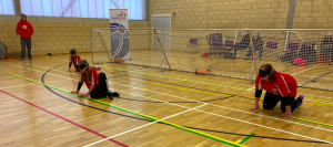 Catrin, Bethan and Gwennan Young on court together in a goalball game.