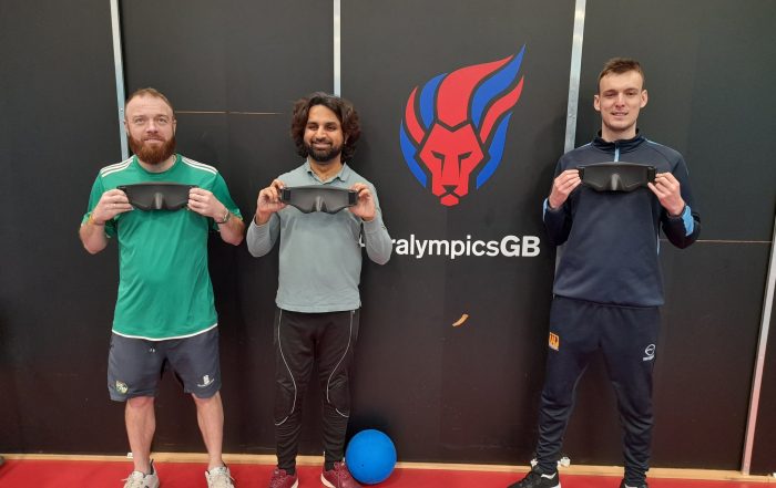 3 South Yorkshire players stood in front of a Paralympics GB sign whilst holding up their new eyeshades.