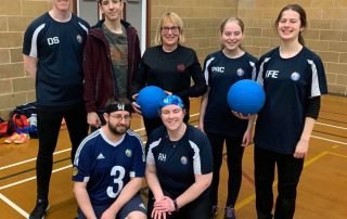 Winchester training session group photo with Kate Exley holding a goalball in her Winchester training shirt.