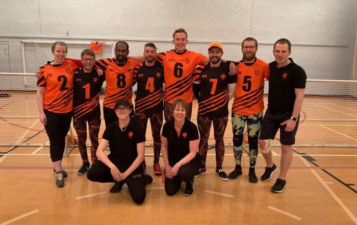 Fen Tigers and Fenland Tigers standing together on court in their tigers jerseys after a super league Matchday.
