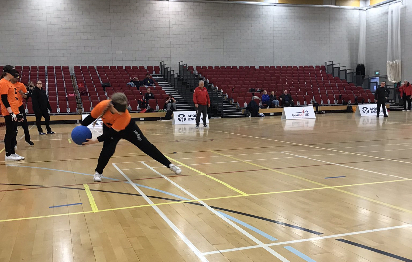 New College Worcester player Phoebe on the right wing about to throw a goalball.