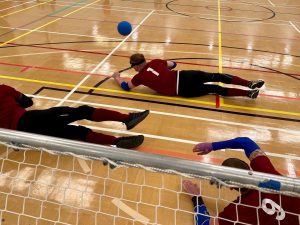 All 3 Northern Allstars players diving out to save the goalball which is heading towards left wing.