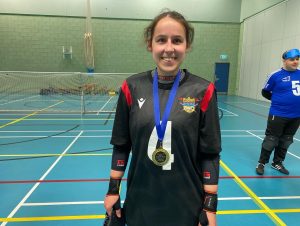 Lauara Brooks of Birmingham goalball club standing with her player of the day medal on court.
