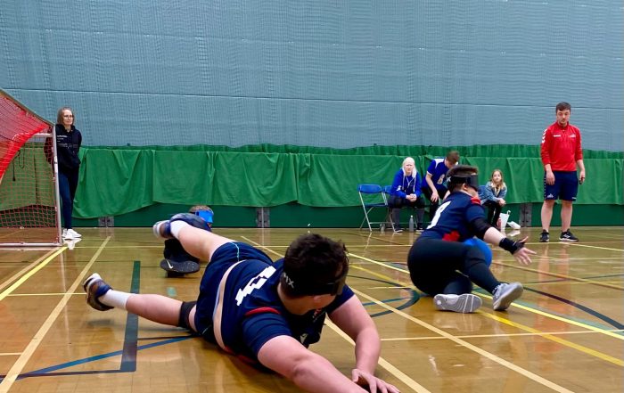 Conall Moore on court playing for RNC Academy in the Novice Shield. Conall is on the right wing and diving inwards towards centre position.