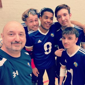 Winchester Kings Intermediate team at a tournament having a group selfie with coach Geoff. Patrick, Devante, Paddy, and Marcus are in the photo too.