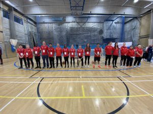 Goalfix Cup 2022 activators and officials standing in one big line going across the goal line in their red activator and referee shirts, what a team! Everyone is smiling as the competition has been completed.