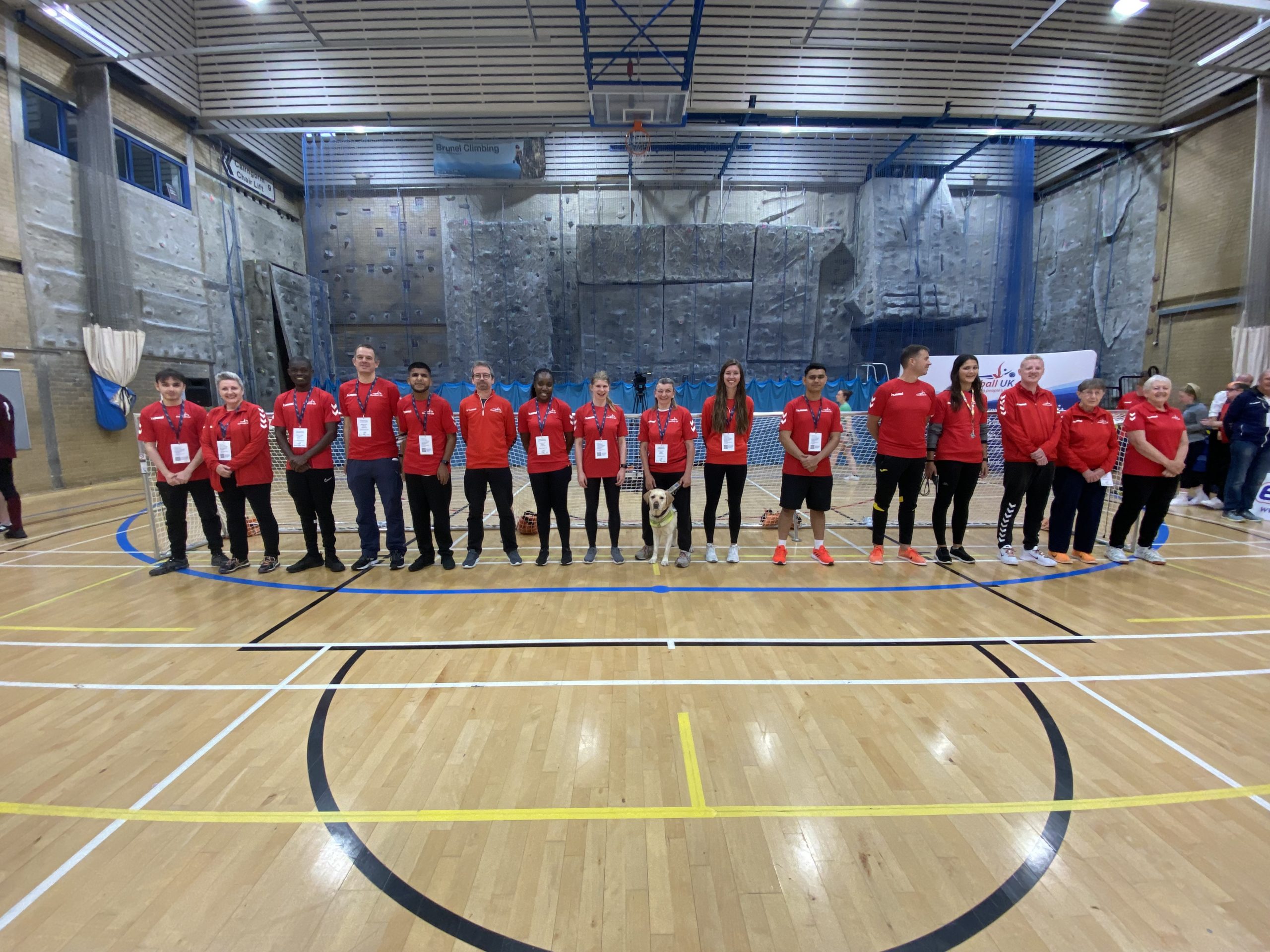 Goalfix Cup 2022 activators and officials standing in one big line going across the goal line in their red activator and referee shirts, what a team! Everyone is smiling as the competition has been completed.
