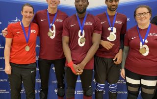 Northern Allstars standing with their gold medals after winning the Goalfix Cup 2022. From left to right: Faye, Matt, Caleb, Naqi, and Emma all in their maroon jerseys.