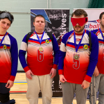 RNCB team with 4 players in their red, white, and blue jerseys with their bronze medals.