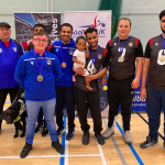 Birmingham silver medallists with coaches Mo an Conna. Player Sal is holding a future goalball star with his baby daughter.