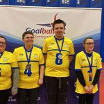 West Yorkshire novice team with their silver medals. All 4 playes are stood with each other in front of a Goalball UK banner.