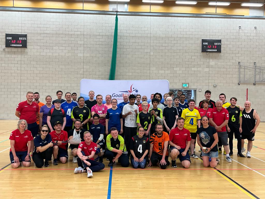 The End of Season 2022 group picture, with players, referees, coaches, and staff coming together making up 4 rows with an array of shirt colours like red, yellow, orange, and blue!