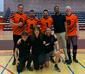 A team photo following the 2nd stage of the S E G L. The Tigers team of Josh, Dom, Dan, and Dave are standing with former teammate Filmon. Coaching team of Dan, Emma, and Joe are kneeling below.