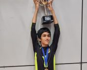 Daniel White - Croysutt Warriors. Daniel is stood with his arms up holding a trophy