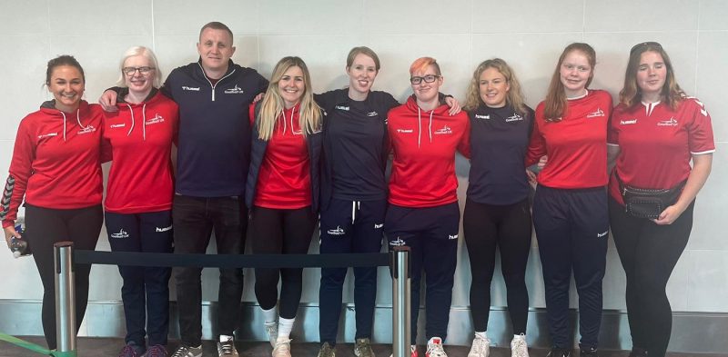 Group photo of the GB Women's team on the way to the Goalball Nations Cup, Berlin 2022. The squad and support staff are standing together facing the camera.