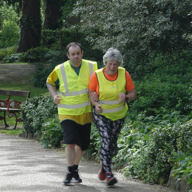 Nick running a Parkrun with a sighted guide