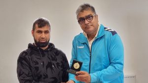 Hamza Azam receiving an award for cricket