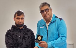 Hamza Azam receiving an award for cricket