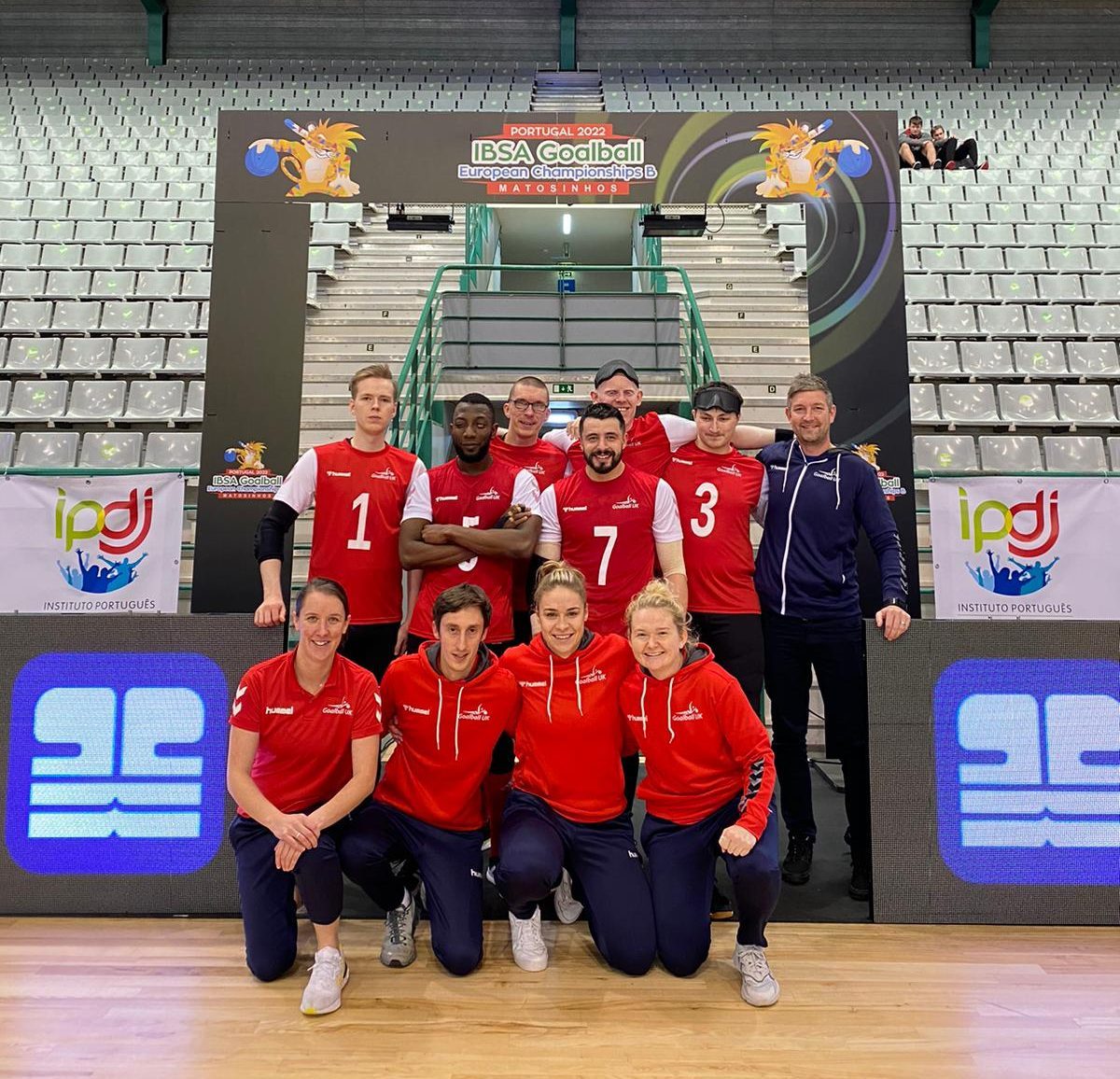 The GB squad including staff posting for a group photo under a branded banner at the Euros.