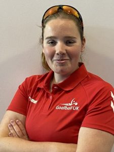 Lois Turner GB Women profile photo. Lois is wearing a red GB polo shirt with sunglasses on top of her head.