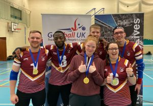 Northern Allstars gold medal winning photo, with everyone in the team smiling in their new maroon jerseys. Left to right: Peter, Caleb, Chelsea, Stu, Emma, and Matt.