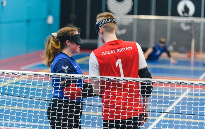 During a game Lois, a GB Women player speaks to Stuart, a GB Men player at the goal