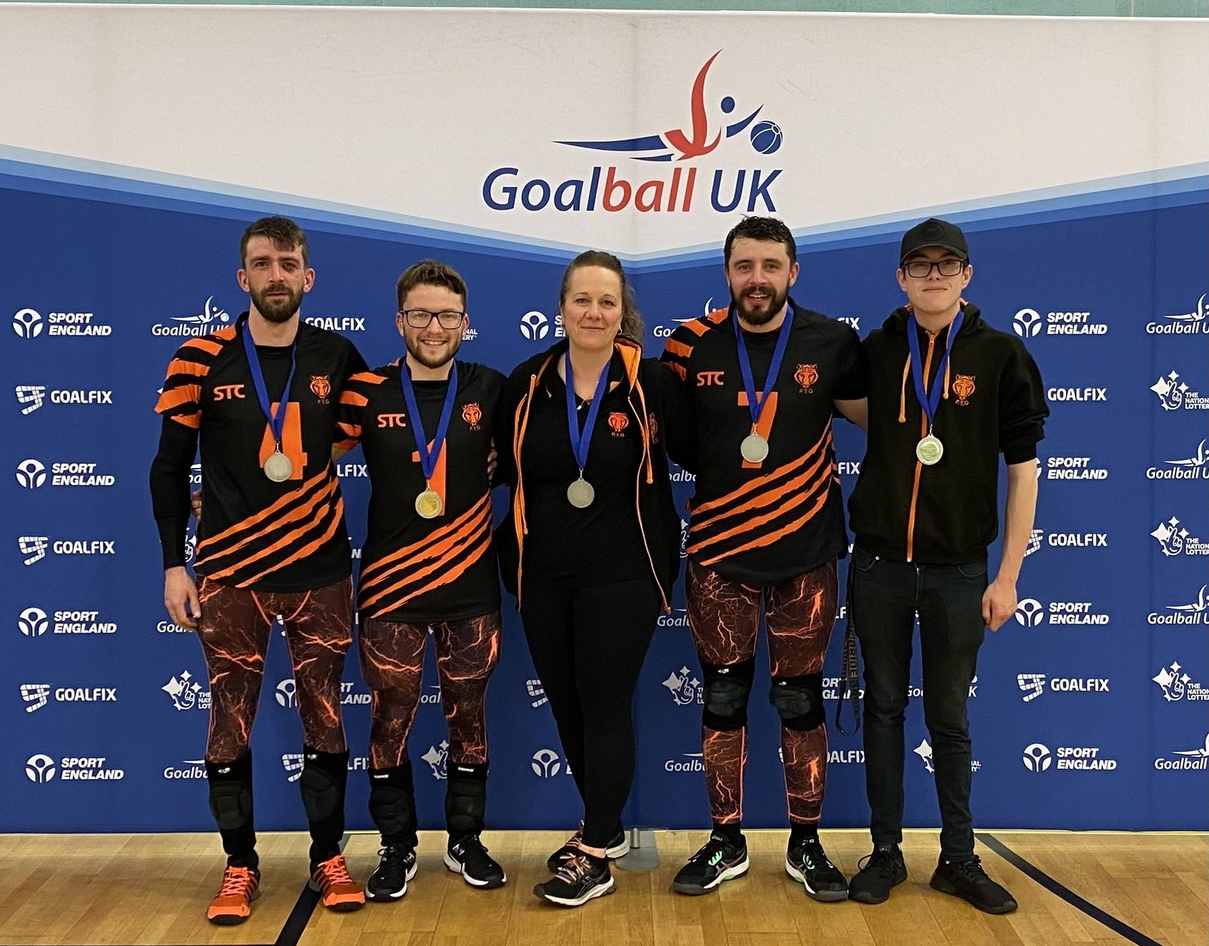 Fen Tigers group picture with their medals at the end of the game