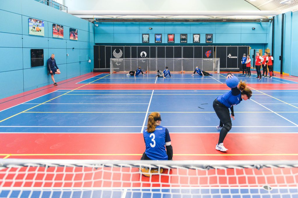 Wide angle view from behind a goalball court during a GB training game