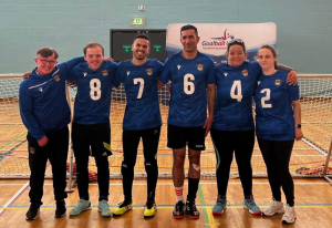 A group photo of Birmingham Goalball Club. They are stood in a line with arms around each other