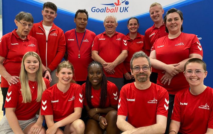 A group of Goalball UK volunteers and activators pose together for a smiley photo at an event
