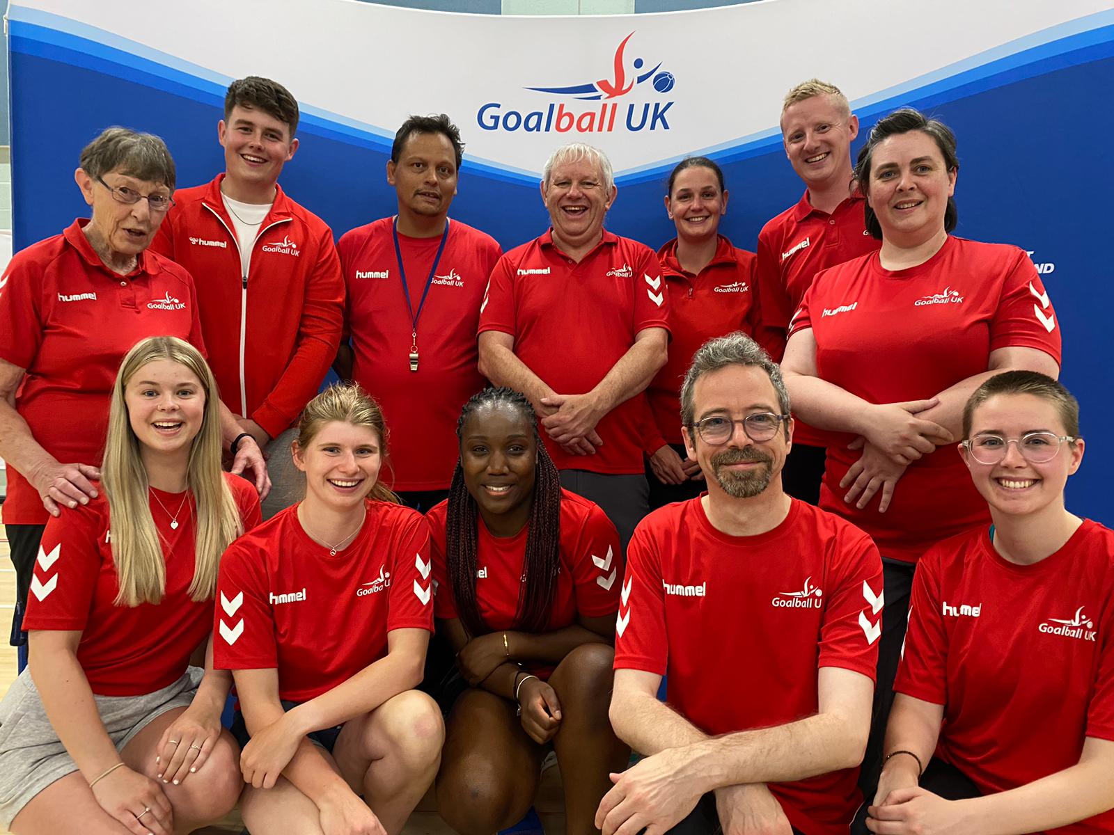A group of Goalball UK volunteers and activators pose together for a smiley photo at an event