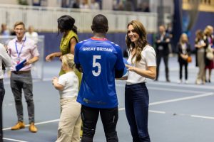 The Princess of Wales, Kate Middleton, stands and speaks to GB Men's Caleb Nanevie
