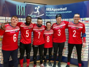 GB Men's goalball athletes pose for a group photo in their red kit