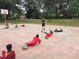 Alex Cockerham leads an outdoor goalball lesson whilst in Tanzania