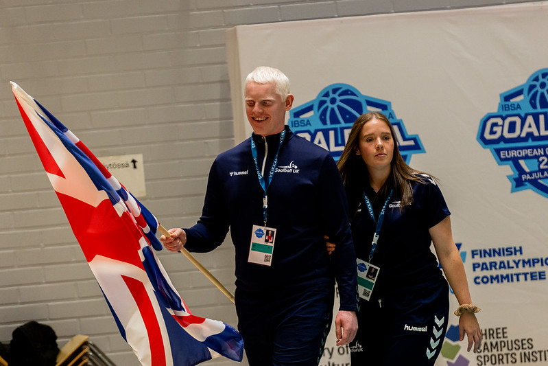 Great Britain flag bearers Lois Turner and David Scott walking with the GB flag at the opening ceremony.