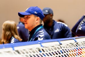 An image of Jack Peters at the opening ceremony with a baseball cap, Jack is standing in front of a goalball goal.