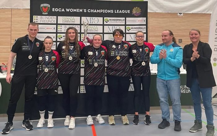 Füchse Berlin squad photo after winning the final of the 2025 Women's Champions League! All players and coaches are standing together in their jerseys, big smiles all round!
