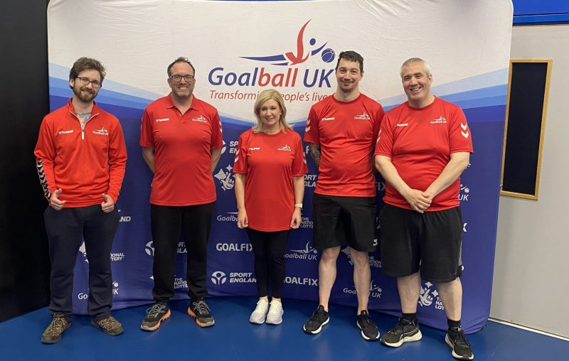 2026 Referees 5 newly qualified referees in red tshirts stood in front of a Goalball UK banner
