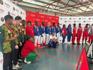 team medallists in front of a banner