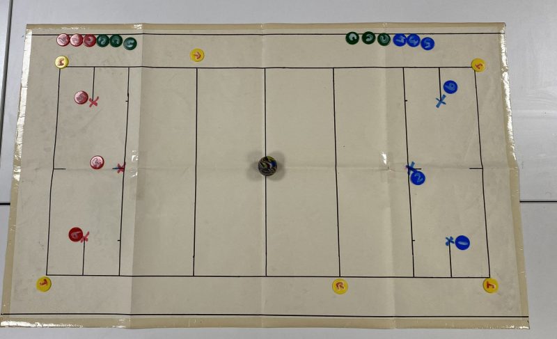 Table Top Court court with tactile markings and counters representing players on a table cloth